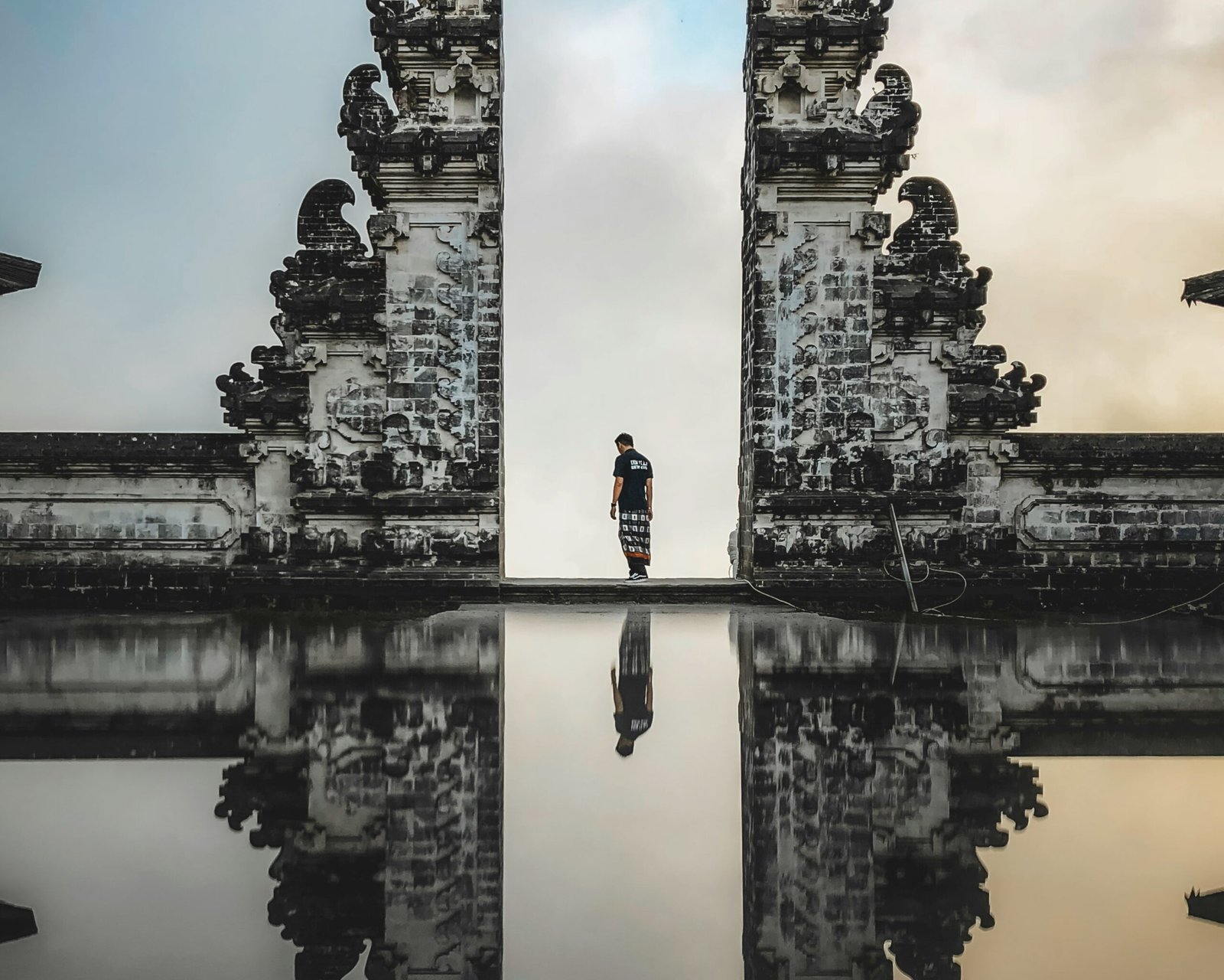 Traveler at Bali Gate of Heaven with mountain view behind